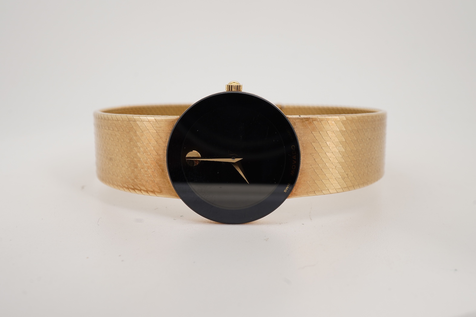 A lady's late 20th century Swiss Movado Museum 14k yellow metal quartz wrist watch, on an integral Italian 14k bracelet
